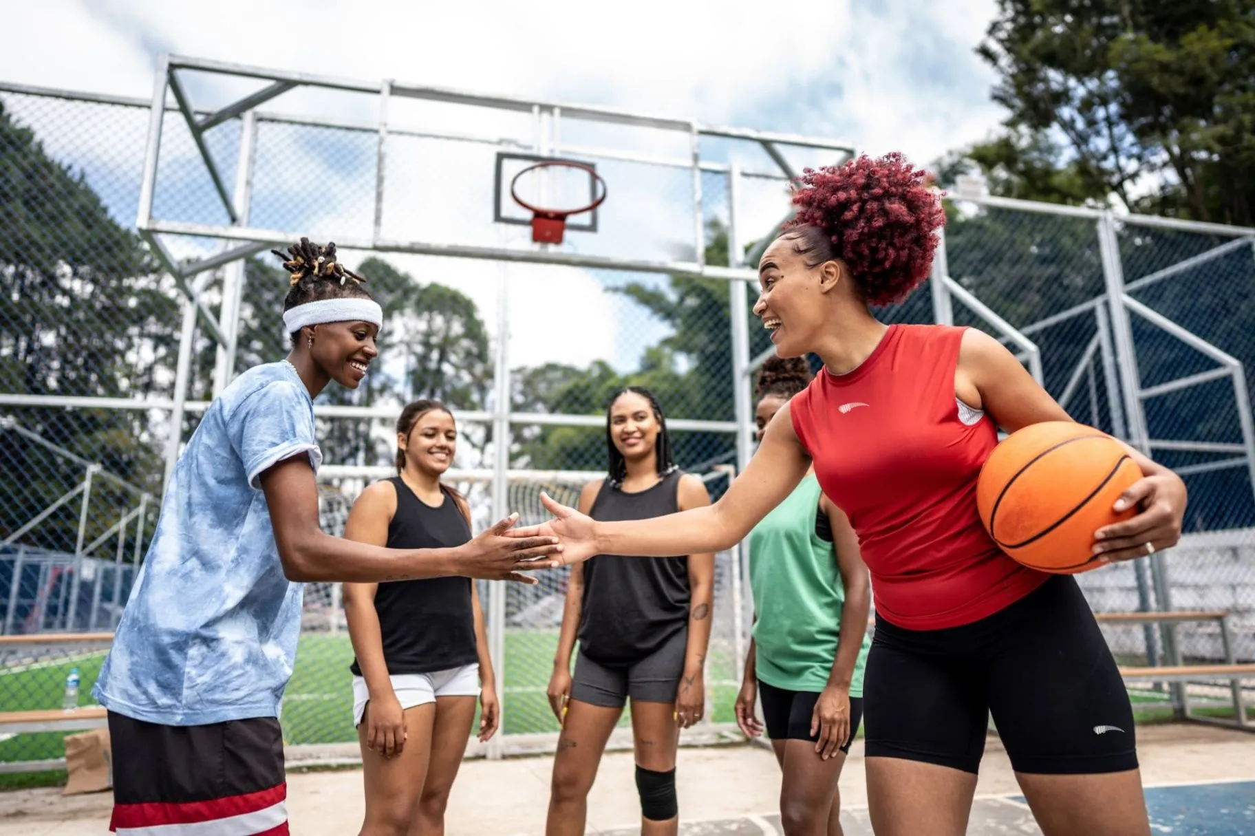 Group of basketball players connecting on an outdoor court